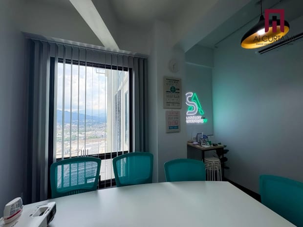 The same meeting room from the other end, the blinds drawn back from a full-height window looking out over the city.
